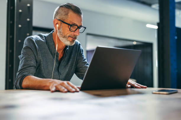 istock Businessman attending a virtual meeting in a modern office 1400064093