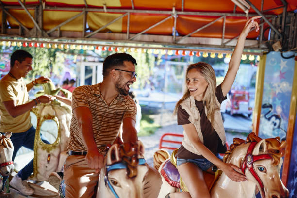 istock Carefree couple having fun during a ride at amusement park. 1400064134