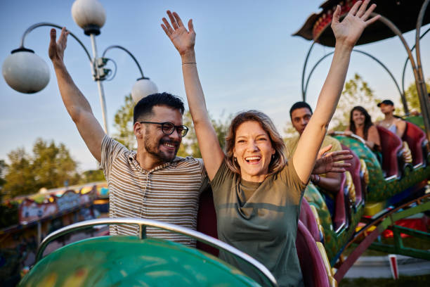 istock Young carefree couple having fun on rollercoaster ride at amusement park. 1400064532