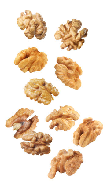 istock Halves of walnuts falling on white background 1400064995