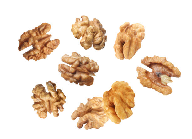 istock Halves of walnuts falling on white background 1400064996
