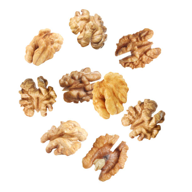 istock Halves of walnuts falling on white background 1400065011