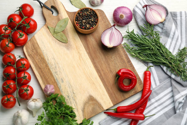 istock Cutting board on white wooden table, flat lay. Cooking utensil 1400065174