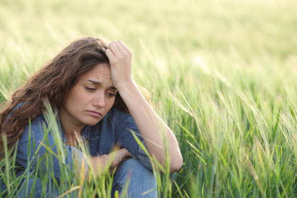 istock Sad woman complaining in a field 1400065575