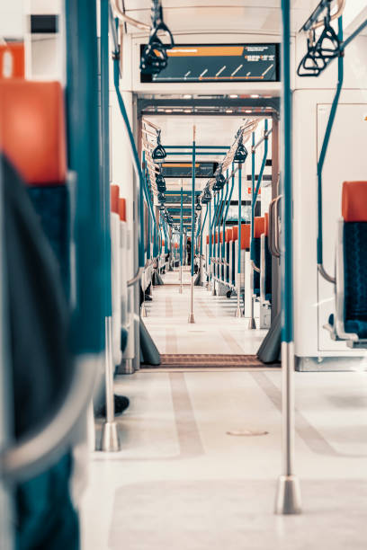 istock Modern train interior. Perspective of empty passenger train car. Rows of unoccupied seats 1400065677