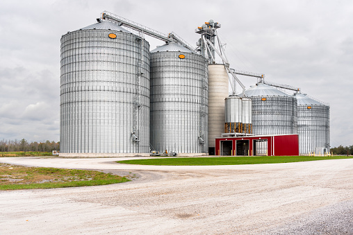 Photo of a large grain elevator under cloudy sky in autumn