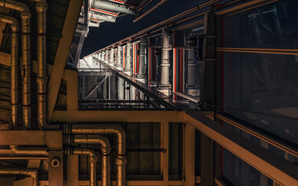 istock Looking up steel construction inside modern building, metal platforms, manifolds and cables visible. Abstract industrial background 1400066547