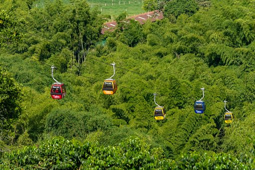 Montenegro, Colombia - 08,09,2021 - Cable cars in motion over National Coffee Park (Parque Nacional del Cafe) The National Coffee Park is a theme park located near the city of Armenia.