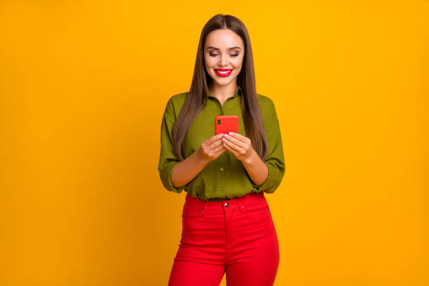 istock Portrait of attractive cheerful straight-haired girl using digital device 5g browsing web isolated over bright yellow color background 1400068452