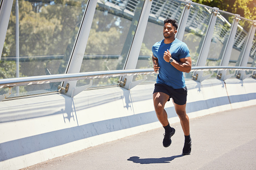 Three Quarter Shot of an Athletic Young Man Doing an Outdoor Running Exercise at the Park