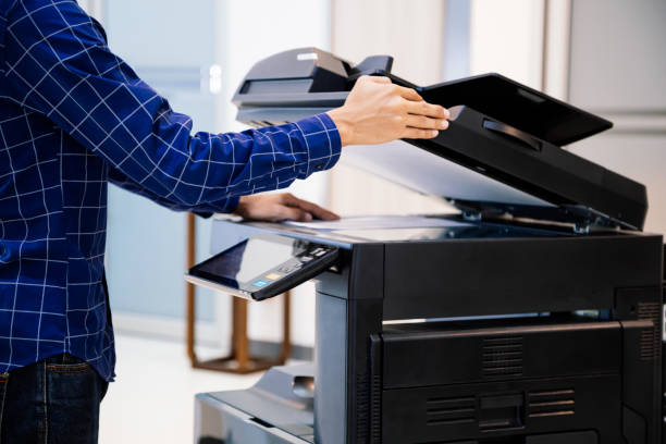 istock Businessmen press button on the panel for using photocopier or printer for printout and scanning document paper at office. 1400070433