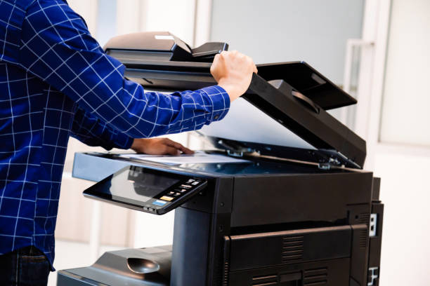 istock Businessmen press button on the panel for using photocopier or printer for printout and scanning document paper at office. 1400070466