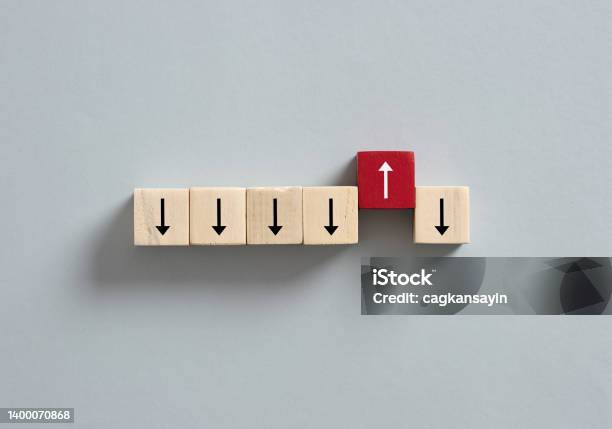 Red Wooden Cube With The Up Arrow Among The Cubes With Down Arrows Stock Photo - Download Image Now