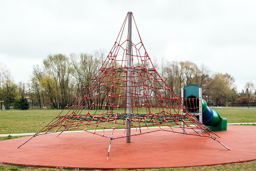 Pyramid ropes for climPyramid ropes for climbing. The sky is cloudy and nobody in the playground.bing. The sky is cloudy and nobody in the playground