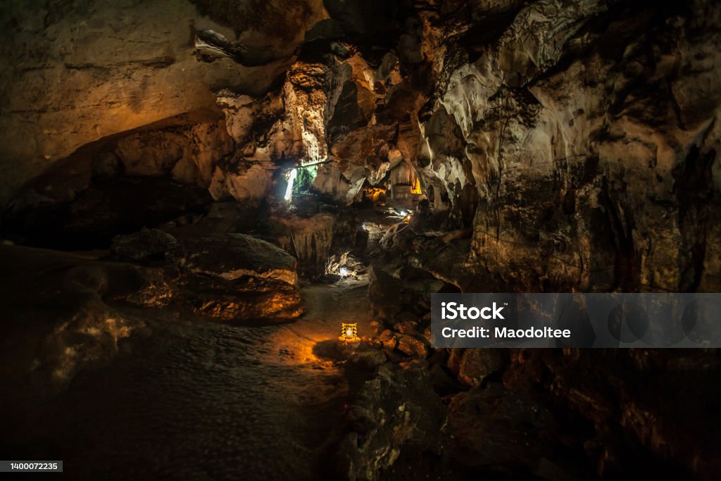 Chomphon Cave in Ratchaburi Province, Thailand Chomphon Cave, is one of the beautiful stalactite cave. Some part of the cave look similar to dolls and thrones and there are walking Buddha image inside Adventure Stock Photo