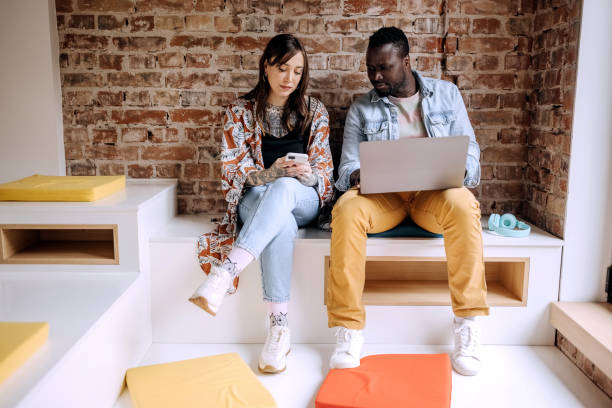 istock Coworkers relaxing in office chill room 1400073639