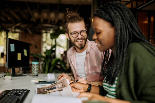 istock Smiling colleagues working together in office 1400075013
