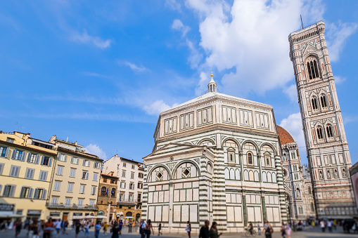 Glimpse of Piazza del Duomo in Florence visited by numerous tourists, where overlooks the cathedral complex: the Cattedrale di Santa Maria del Fiore, the Battistero di San Giovanni and the Giotto's Campanile, all part of the UNESCO World Heritage Site.