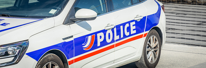 French police car parked in a street of Paris, France