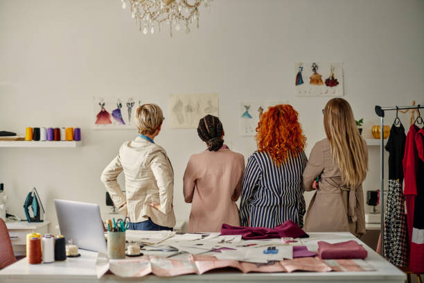 istock Four fashion designer looking at sketches 1400079062