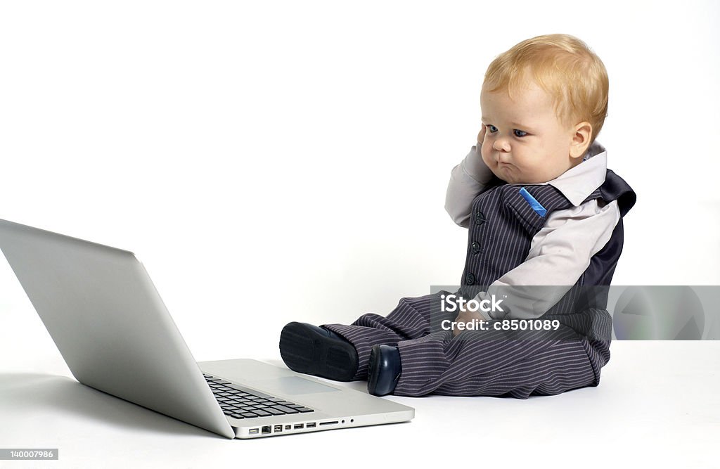 baby thinking laptop blond baby in suit working with laptop and thinking Baby - Human Age Stock Photo