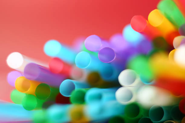 Colorful blurred red background with many drinking straws