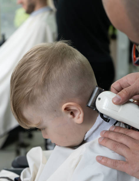 istock little blond boy is having hair cut 1400082427