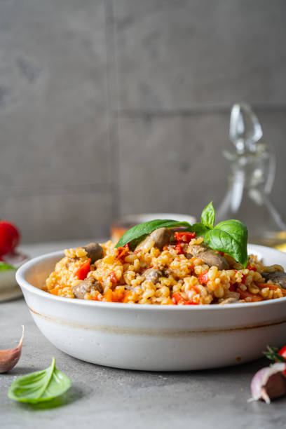 Bulgur with chicken hearts bulgur with chicken hearts and vegetables. Delicious healthy dish on a gray background. Bulgur pilaf bulgur wheat stock pictures, royalty-free photos & images