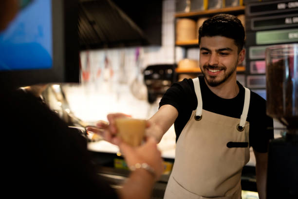 istock Waiter serving coffee to customer 1400083204