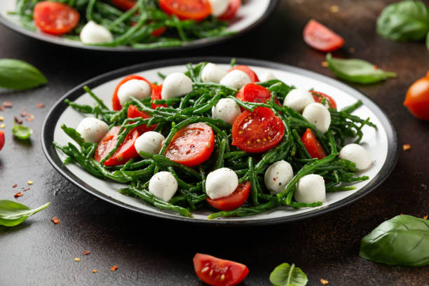 Fresh Samphire salad with cherry tomatoes and mozzarella. Healthy food. Fresh Samphire salad with cherry tomatoes and mozzarella. Healthy food salicornia europaea stock pictures, royalty-free photos & images
