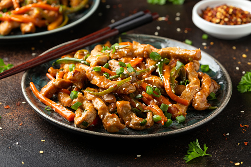 Thai Stir-Fried Chickenwith Chopsticks Directly Above Photo on White Background
