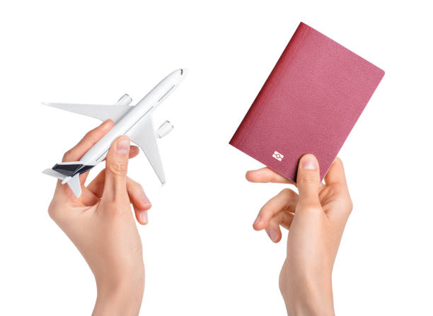 istock Hands holding airplane and red passport on white background. 1400084966