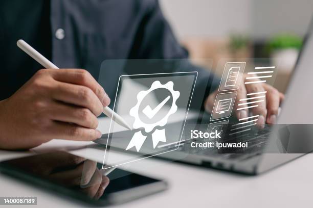 Topquality Service Guarantee And Iso Certification And Standardization Idea Emblazoned On The Shoulders Of A Businessman Stock Photo - Download Image Now