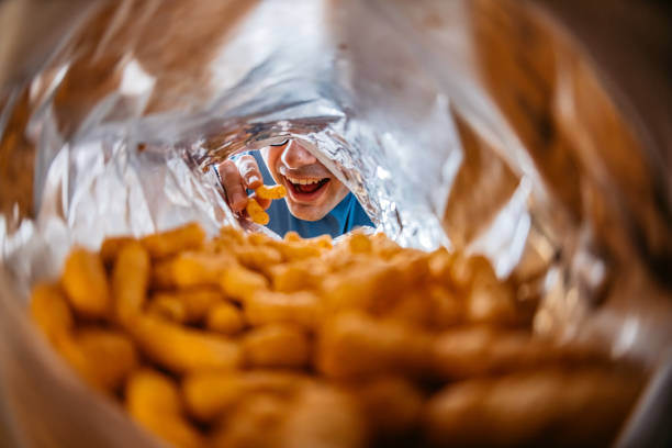 istock Young Man Eating Flips From The Bag's POV 1400088531