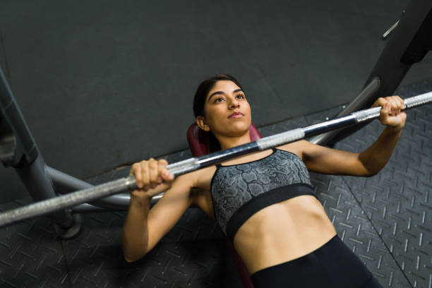istock Beautiful strong woman lifting weights 1400088726
