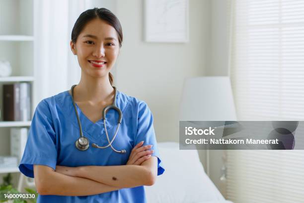 Portrait Of Young Asian Woman Nurse Smiling In Nursing Home Or Hospital Look At Camera Stock Photo - Download Image Now