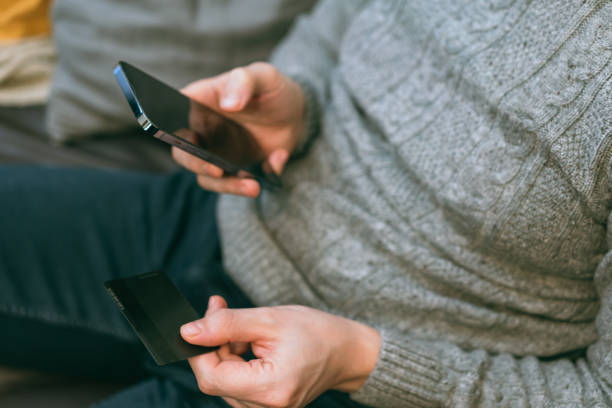 istock man use smartphone and credit card 1400090662