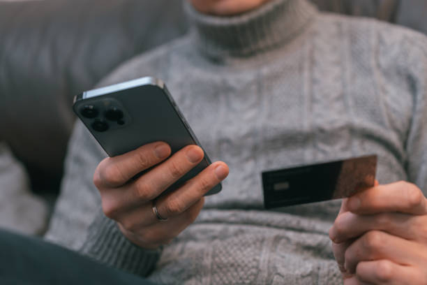 istock man use smartphone and credit card 1400090669