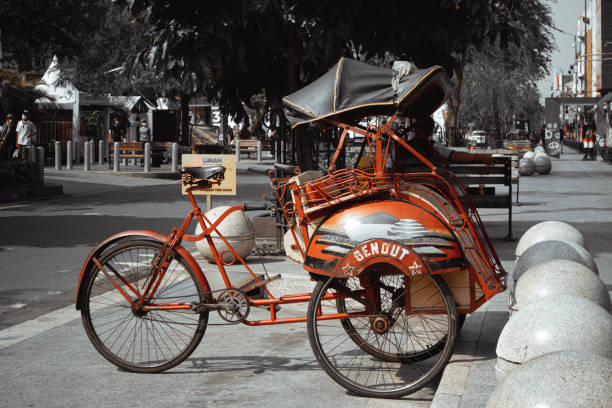 Pedicab Yogyakarta, Indonesia, May 2022 - Pedicab parked on the side of the road in the city of Yogyakarta no rickshaws sign stock pictures, royalty-free photos & images