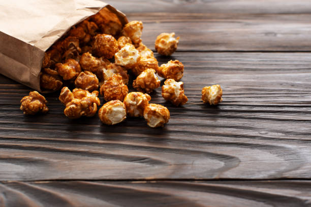 istock Caramelized popcorn in paper bag on wooden kitchen table 1400093000
