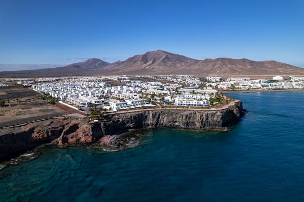 Aerial view of Playa Blanca, Lanzarote, Canary islands, Spain Flying over Playa Blanca, Lanzarote dormant volcano stock pictures, royalty-free photos & images