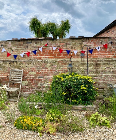 Platinum Jubliee Bunting on old brick garden wall