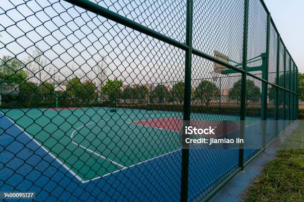 Basketball Court Behind Barbed Wire Stock Photo - Download Image Now - Fence, Sport, Grid Pattern