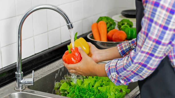 istock Washing vegetables in the kitchen sink 1400096409