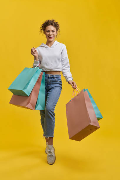 istock Pretty girl holding packages, making step. 1400097298