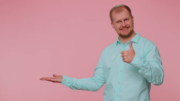 istock Man pointing empty place, advertising area for commercial text, copy space for goods promotion 1400097430