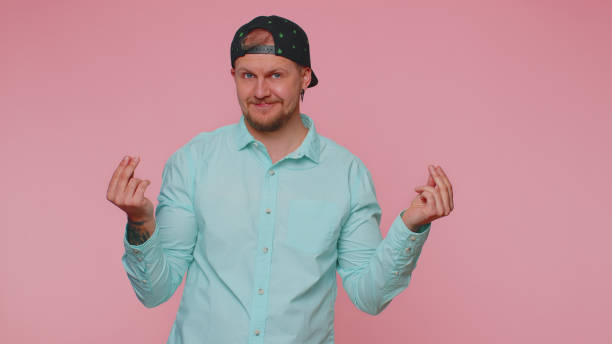 istock Rich man showing wasting or throwing money around hand gesture, more tips dreaming about big profit 1400097976