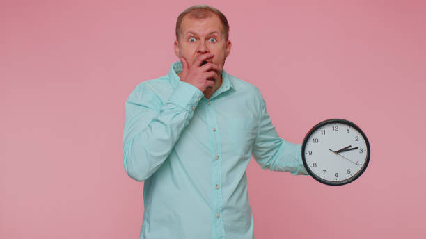 istock Confused man with anxiety checking time on clock, running late to work, being in delay, deadline 1400098023
