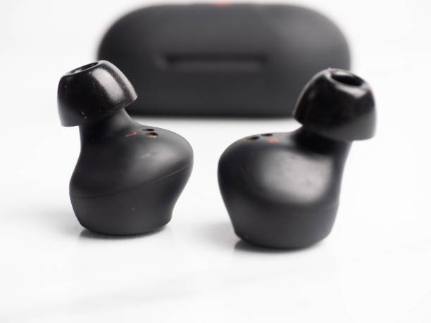 a pair of black wireless earphone with case - cotton swab audio imagens e fotografias de stock