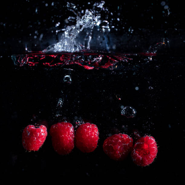 Raspberries fall into the water